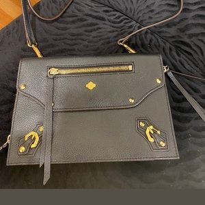 Leather bag with side gold zipper pull.